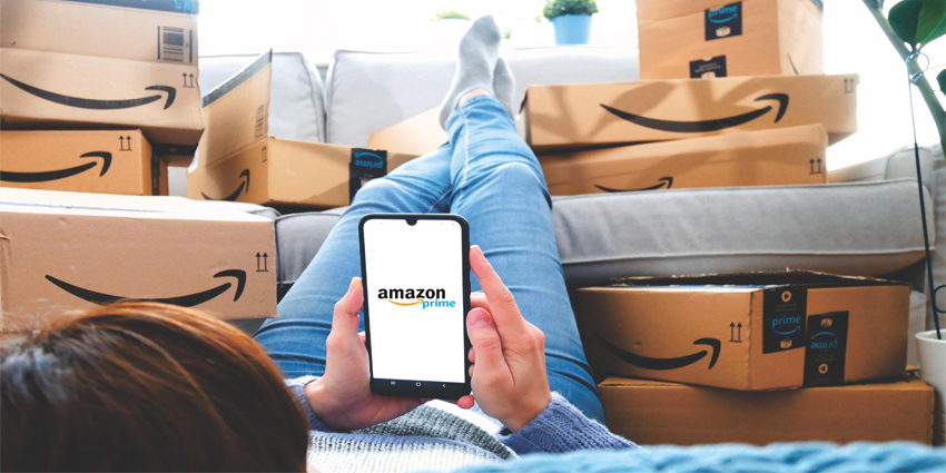 Stack of Amazon Prime packages. woman shopping online at Amazon Prime Day. Distance, home and online shopping