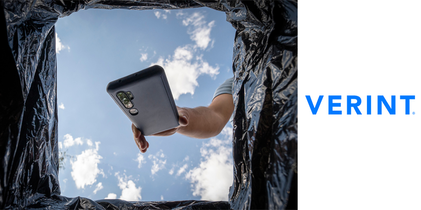 Young man throwing smartphone in litter bin outdoors. Recycling broken smartphone.