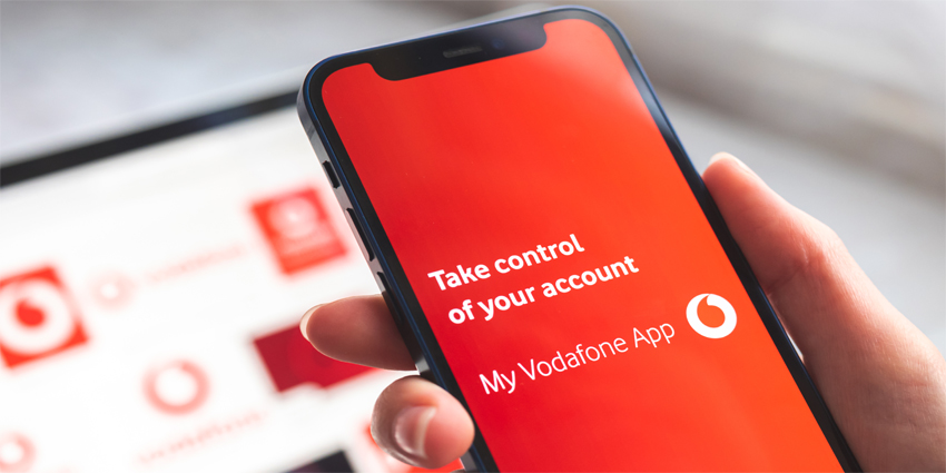 My Vodafone app. Mobile phone in woman hand with title screen of mobile network